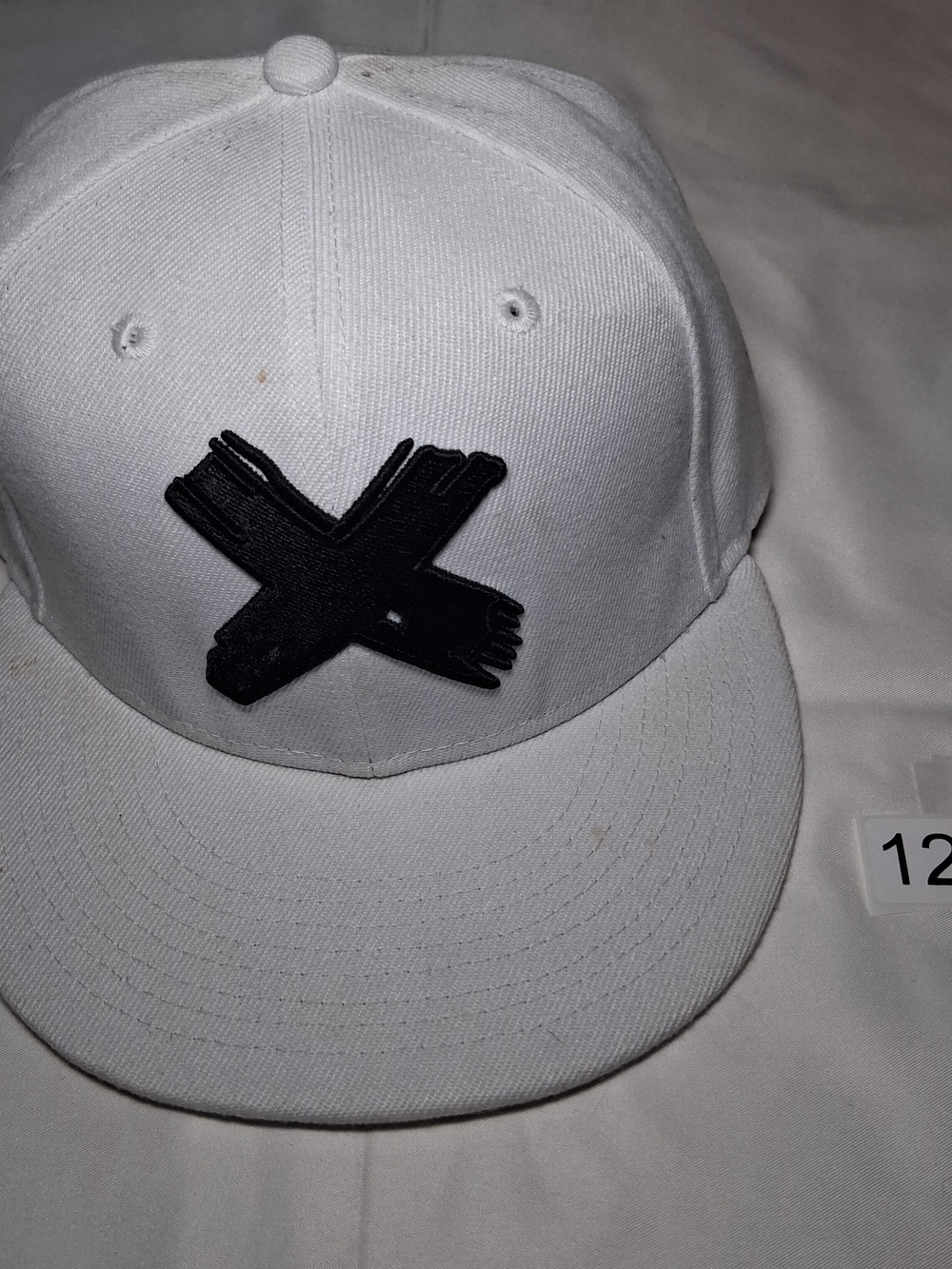 White Snapback Hat with Black 'X' Embroidered Patch